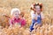 Kids in Bavarian costumes in wheat field