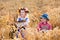 Kids in Bavarian costumes in wheat field