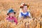 Kids in Bavarian costumes in wheat field