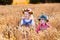 Kids in Bavarian costumes in wheat field