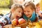 Kids biting autumnal apples