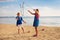 Kids blow bubble at beach. Child with bubbles