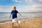 Kids blow bubble at beach. Child with bubbles