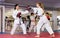 Kids boxing with trainer during karate training