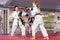 Kids boxing with trainer during karate training