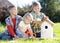 Kids brothers making nesting box together on lawns in summertime