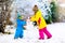 Kids building snowman. Children in snow. Winter fun.