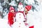 Kids building snowman. Children in snow. Winter fun.