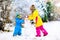 Kids building snowman. Children in snow. Winter fun.