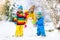 Kids building snowman. Children in snow. Winter fun.