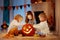 Kids carving pumpkin on Halloween. Trick or treat.