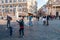 Kids catching and blowing soap bubbles flying on Piazza del Popolo, People Square in Rome full of people, tourists and locals with