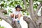 Kids climb tree in summer park. Child climbing