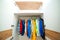 Kids clothing on the hangers. White modern closet inside. Storage organization. Order and cleanliness