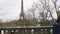 Kids coming back to from school walking on Pont de Bir-Hakeim with Eiffel Tower