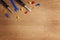 Kids construction toys tools: colorful screwdrivers, screws and nuts on wooden background. Top view. Flat lay.