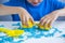 Kids creativity. Kinetic sand games for child development at home. Sand therapy. Children`s hands making moldes. Selective focus,