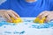 Kids creativity. Kinetic sand games for child development at home. Sand therapy. Children`s hands making moldes. Selective focus,