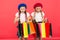 Kids cute schoolgirls hold bunch shopping bags. Children satisfied by shopping red background. Obsessed with shopping