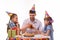 Kids and dad joyfully banging glasses of juice at a birthday party