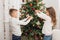 Kids decorating christmas tree