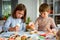 Kids decorating cookies for Halloween