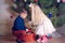 Kids Decorating a Home Christmas Tree with Balls