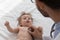 Kids doctor examining cute baby, applying stethoscope to chest