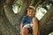 Kids dont need much to be entertained. an adorable little boy playing in a tree at the park.