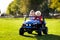 Kids driving electric toy car. Outdoor toys