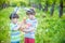 Kids on Easter egg hunt in blooming spring garden. Children sear