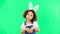 Kids, easter and playful with a girl on a green screen background in studio feeling silly while having fun. Children