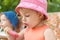 Kids eat popsicles. Brother and sister with fruit ice cream in park. Pretty girl in pink hat spend time outside.Vacation