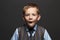 Kids emotion.fashionable little boy.stylish funny child in suit and tie