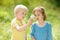 Kids exploring nature with magnifying glass. Close up. Little boy and girl looking with magnifying glass