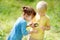 Kids exploring nature with magnifying glass. Close up. Little boy and girl looking with magnifying glass on camomile