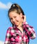 Kids fashion concept. Kid girl checkered fashionable shirt posing sunny day blue sky background. Child cute girl long