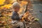 Kids fashion. Happy childhood. Childhood memories. Child autumn leaves background. Warm moments of autumn. Toddler boy