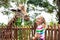 Kids feed giraffe at zoo. Children at safari park.