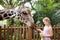 Kids feed giraffe at zoo. Children at safari park