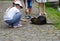 kids feeding a water rat or nutria