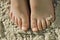 Kids feet in sandy beach fun