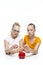 Kids Financial Ideas. Caucasian Teenager Twin Girls Posing With Coins and Piggy Bank. Storing Up Money For Savings