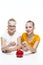 Kids Financial Ideas. Happy Caucasian Teenager Twin Girls Posing With Coins and Piggy Bank. Storing Up Money For Savings