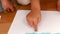 Kids finger painting on sheets of paper