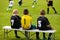 Kids Football Team. Young Soccer Players Sitting in a Row on a Wooden Bench