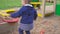 Kids Games. Baby boy digging in the sandbox. Smiles and touches the sand.