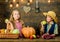 Kids girl boy fresh vegetables harvest rustic style. Children presenting harvest vegetable wooden background. Fall