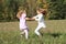 Kids - girls dancing on meadow
