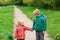 Kids go to school - brother and sister with backpacks on the road